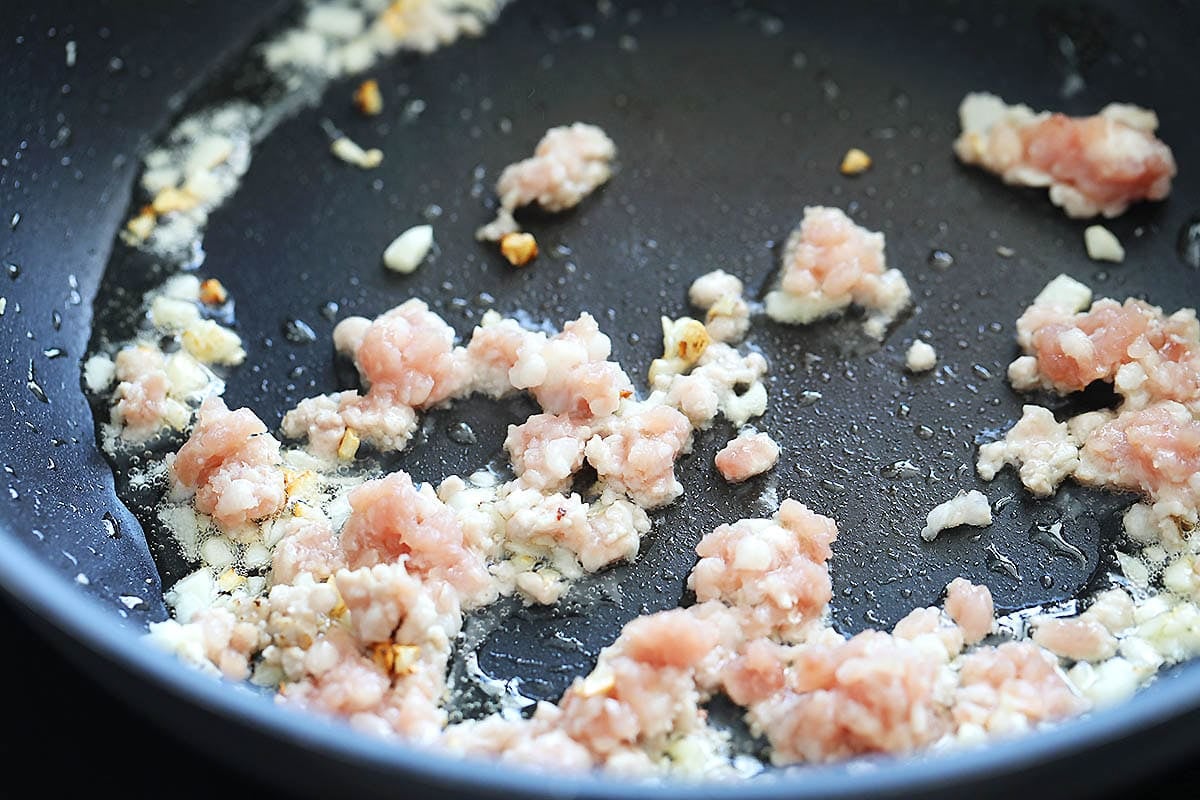 Ground pork and garlic in a pan.