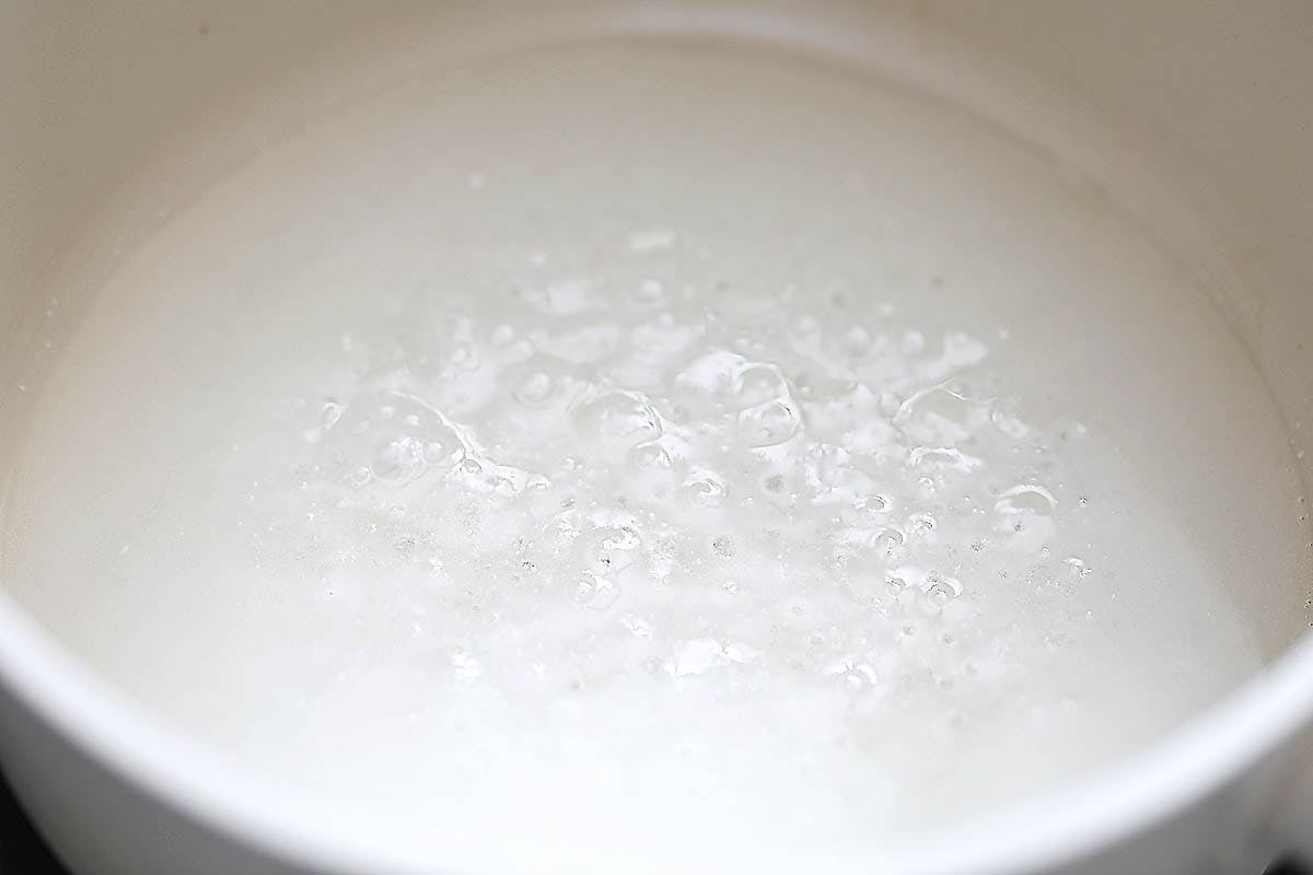 Sugar mixture simmering in a saucepan.