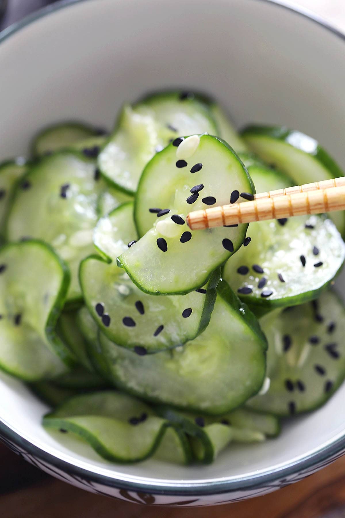 Simple Japanese cucumber salad garnished with black sesame seeds.