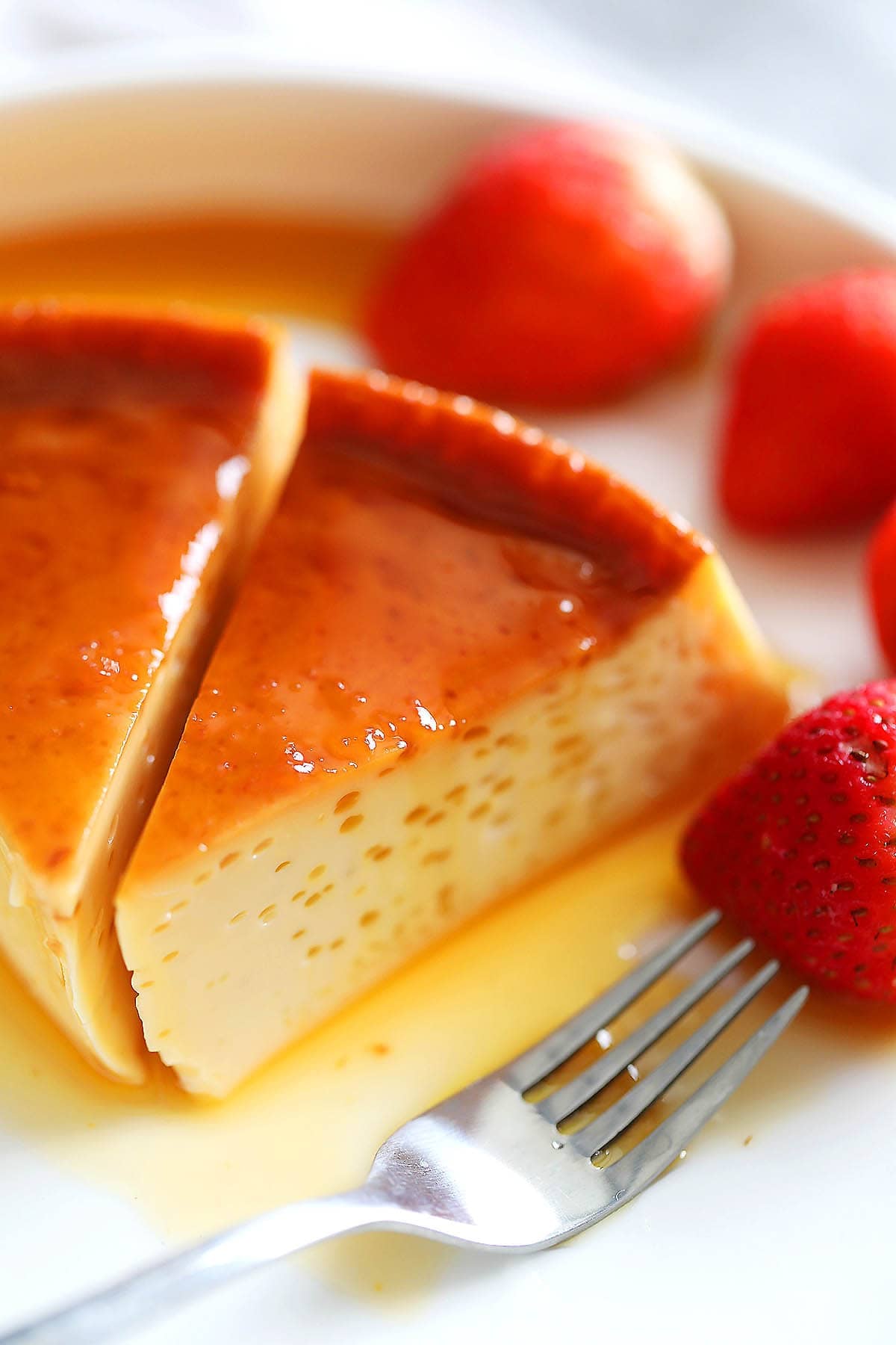 Slices of quesillo served with strawberries.