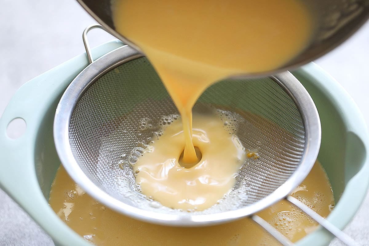 Custard mixture being strained.