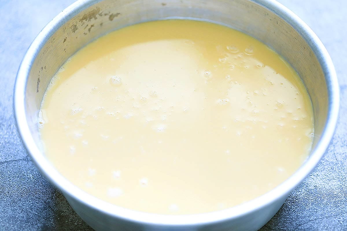 Custard mixture in a cake pan.