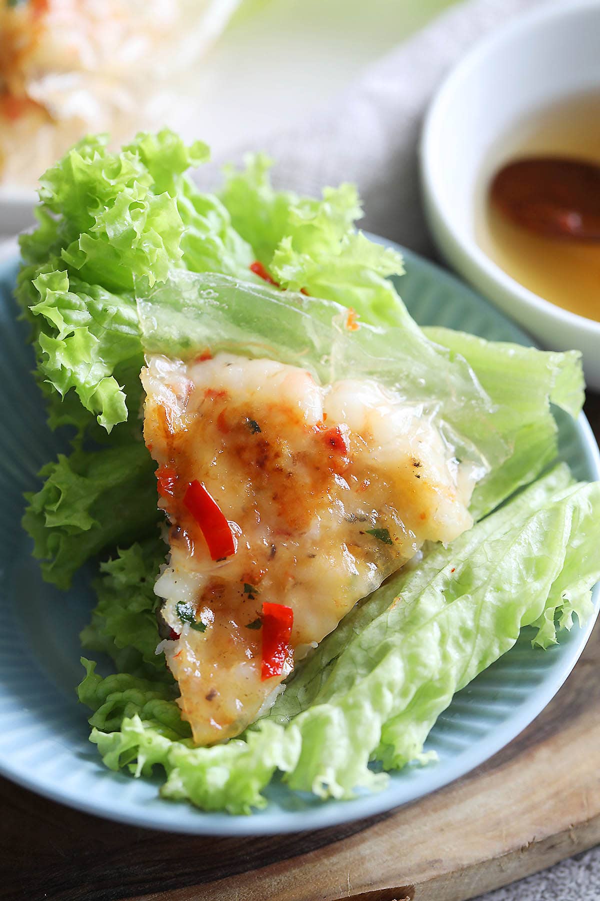 Vietnamese shrimp cake on top of a lettuce and drizzled with Vietnamese dipping sauce (nuoc cham).