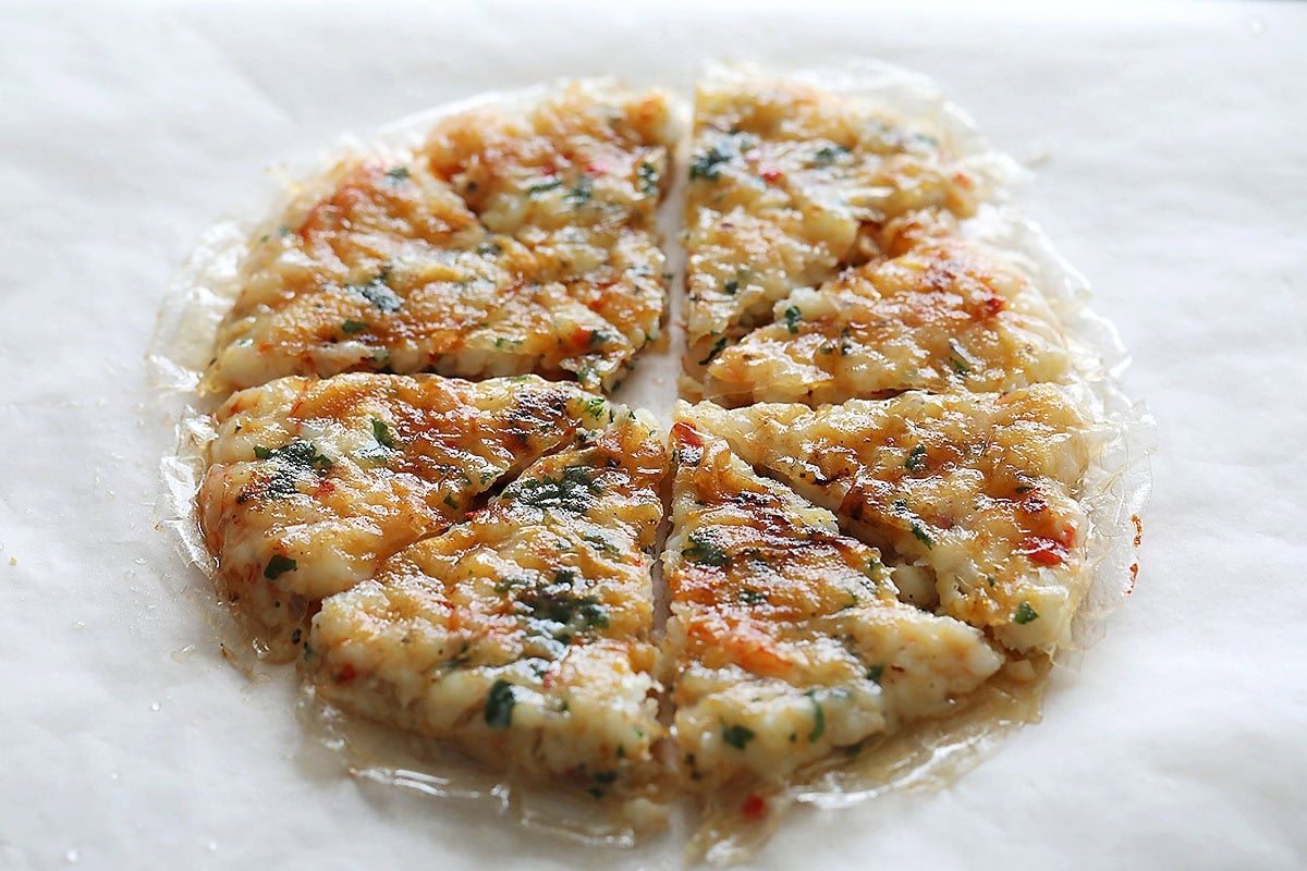 Golden brown Vietnamese shrimp cakes on a parchment paper.