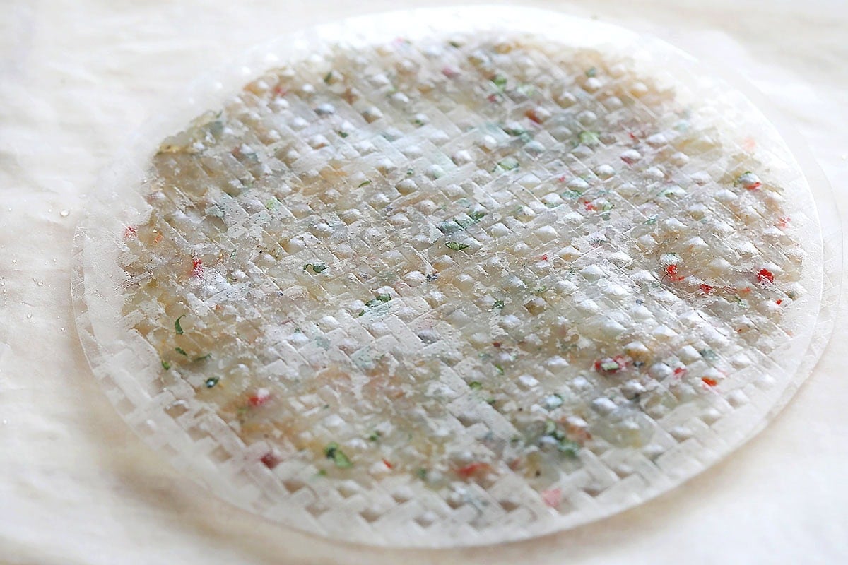 Uncooked shrimp cake on a parchment paper.