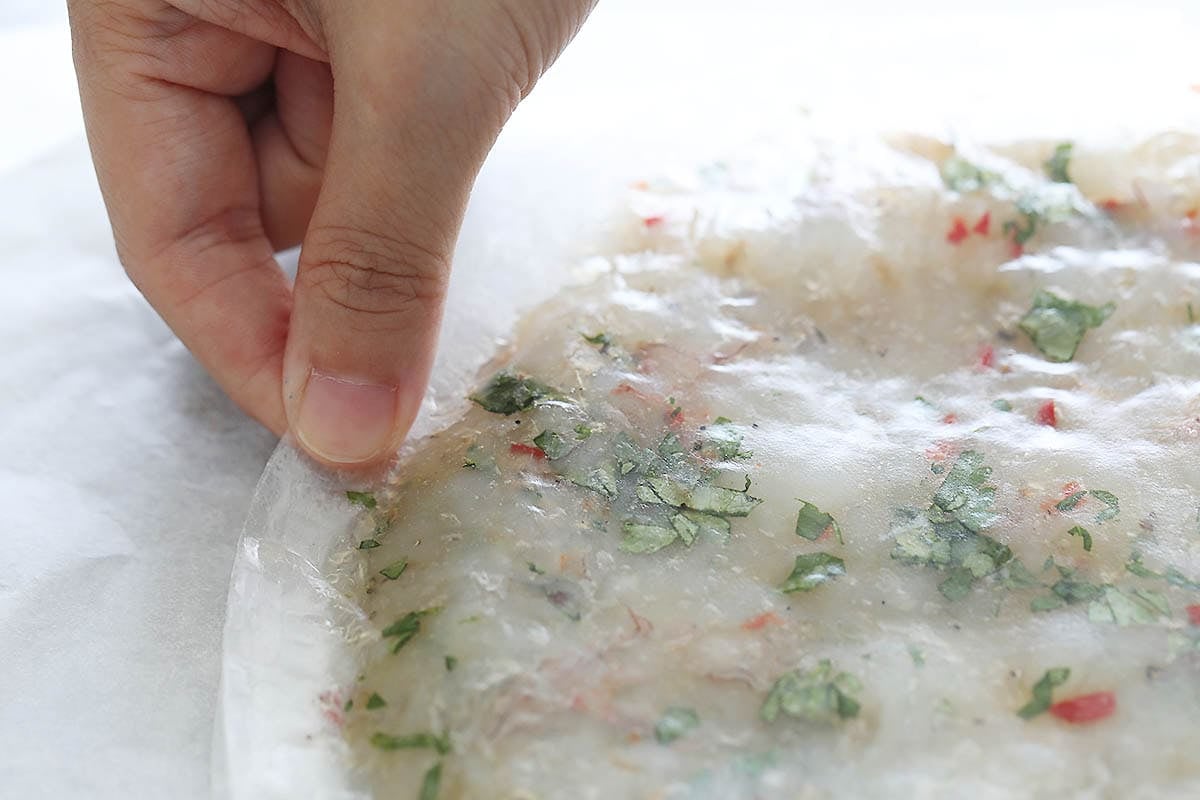 Pinching the edges of the shrimp cake.