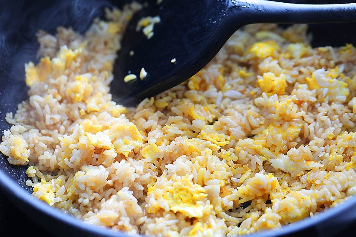Fluffy eggs and rice in a pan.