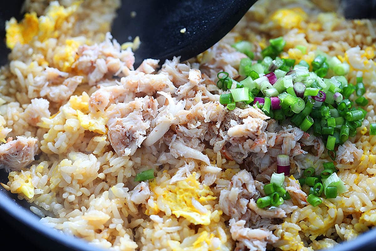 Crab meat and scallions on top of the eggs and rice.