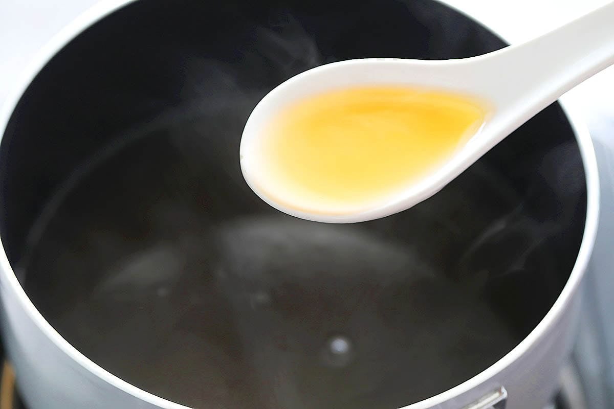 A spoonful of golden ankake sauce.