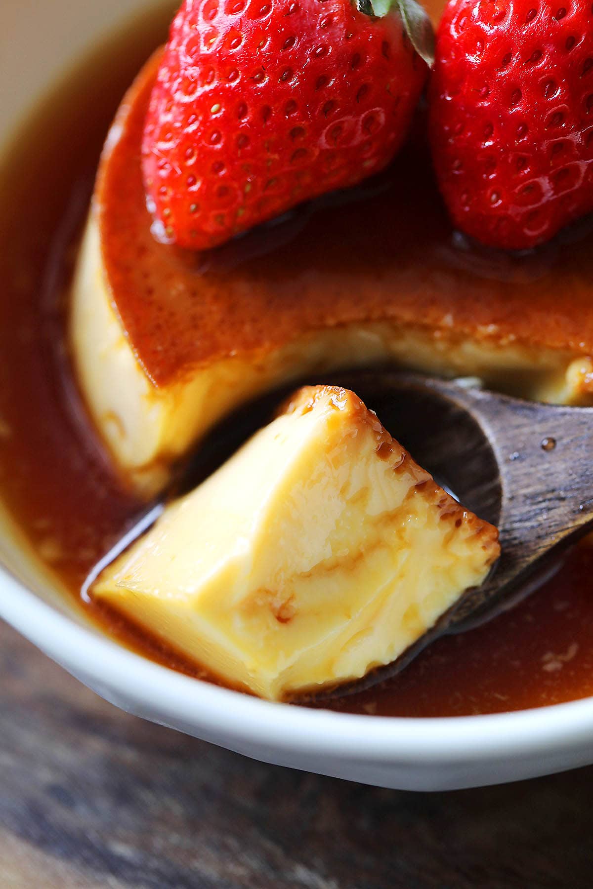 Silky, smooth flan served with strawberries.