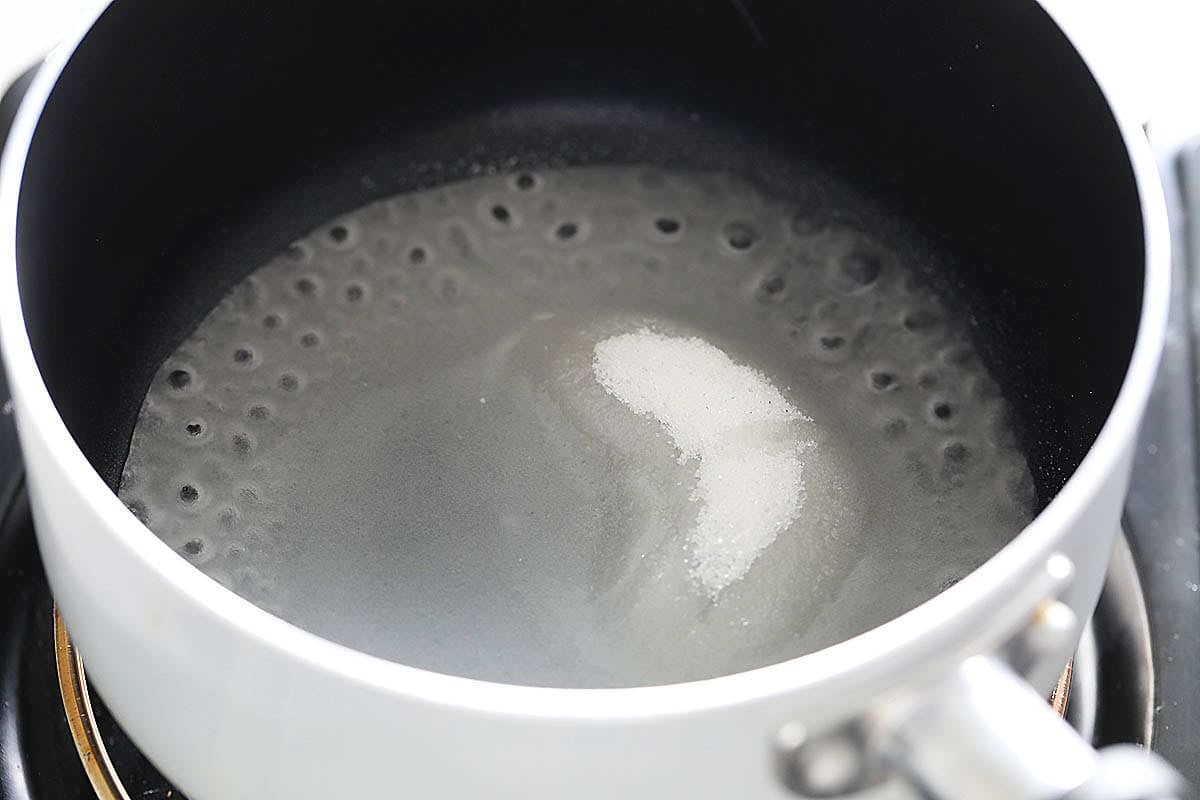 Sugar and water in a saucepan.