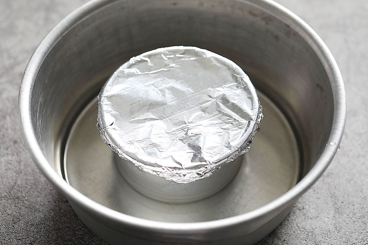 Covered tin mold in a shallow water bath.