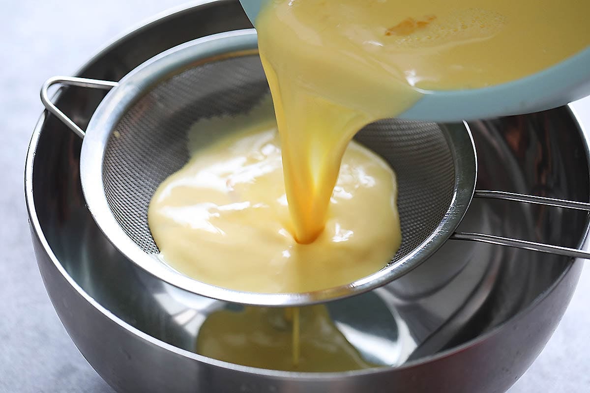 Egg mixture being strained.