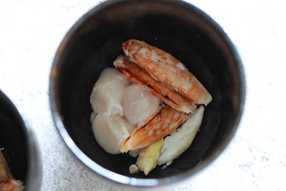 Chicken cubes and crab meat in a chawanmushi cup.