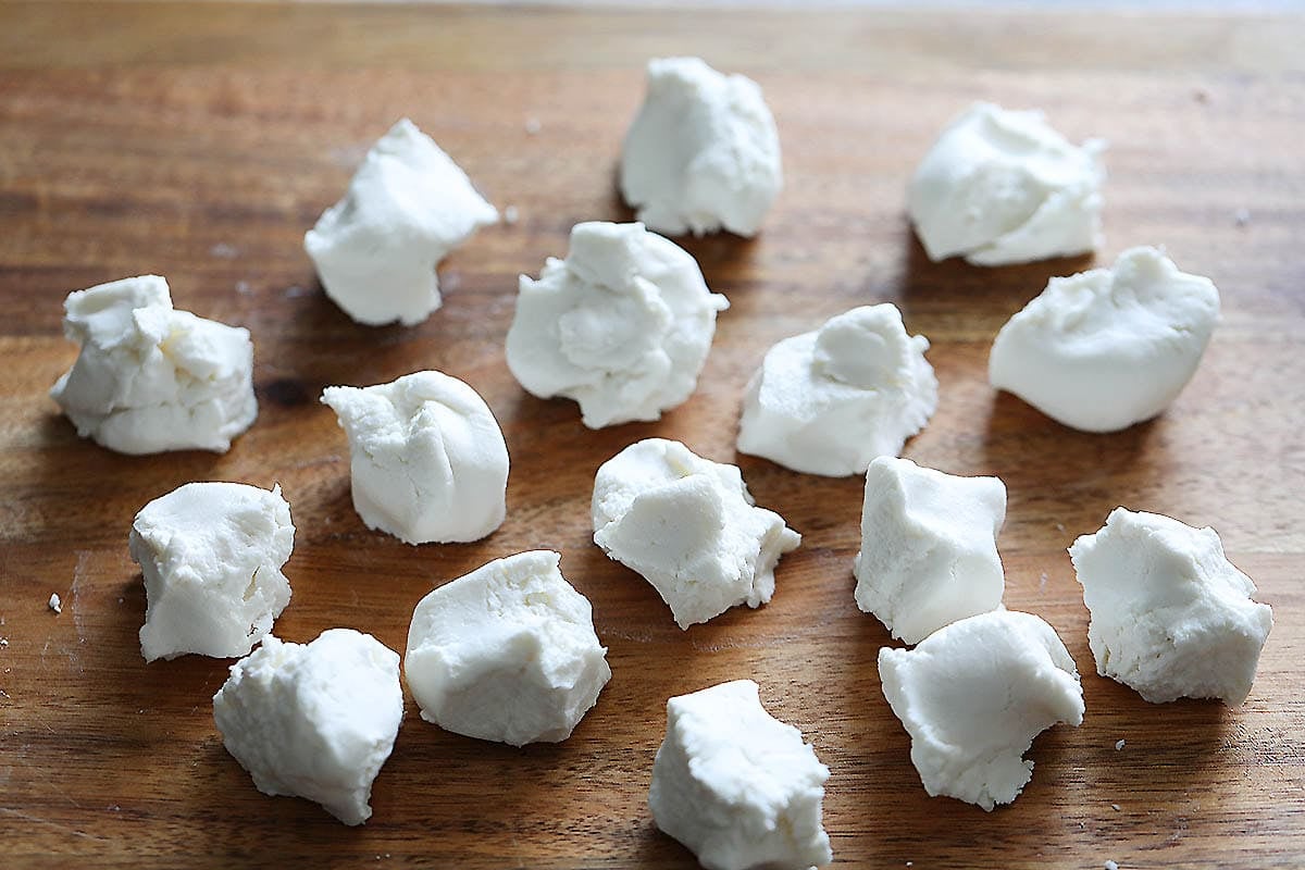 Pieces of dough on a chopping board.