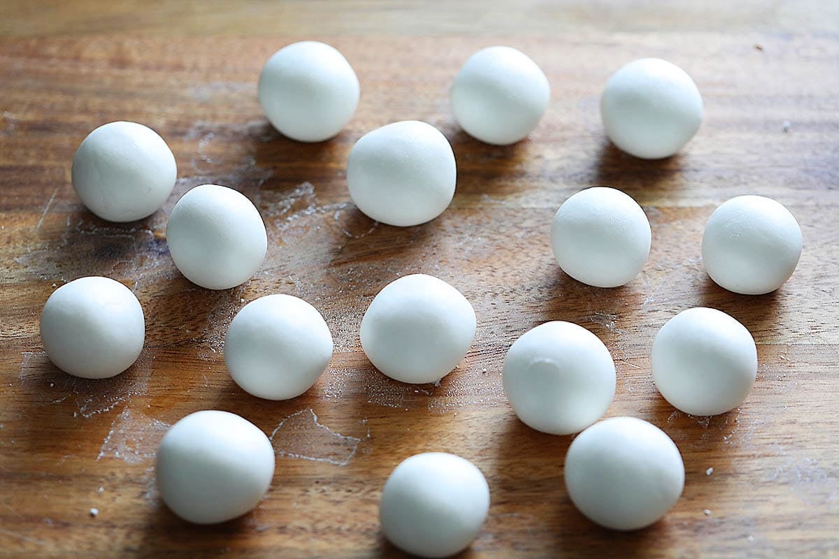 Uncooked shiratama dango on a chopping board.