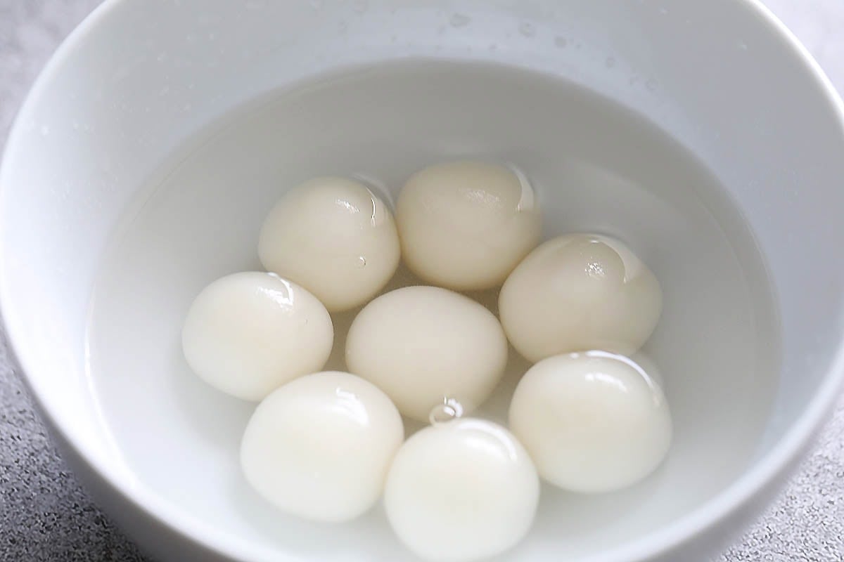 Shiratama dango in a bowl of cold water.