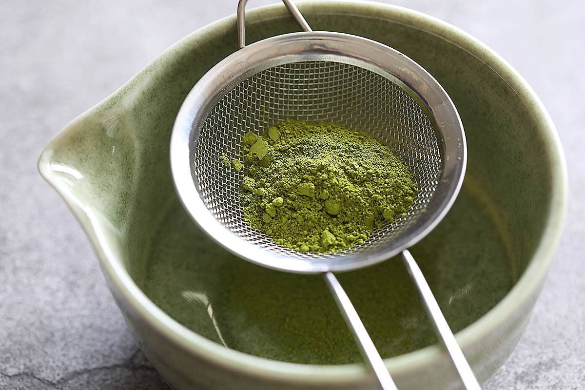 Matcha powder on a fine mesh sieve.