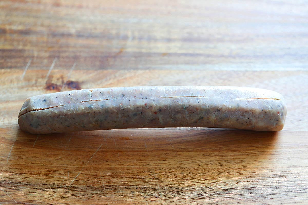 A shallow cut along the sausage.