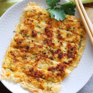 Prawn cake served with a side of chili sauce.