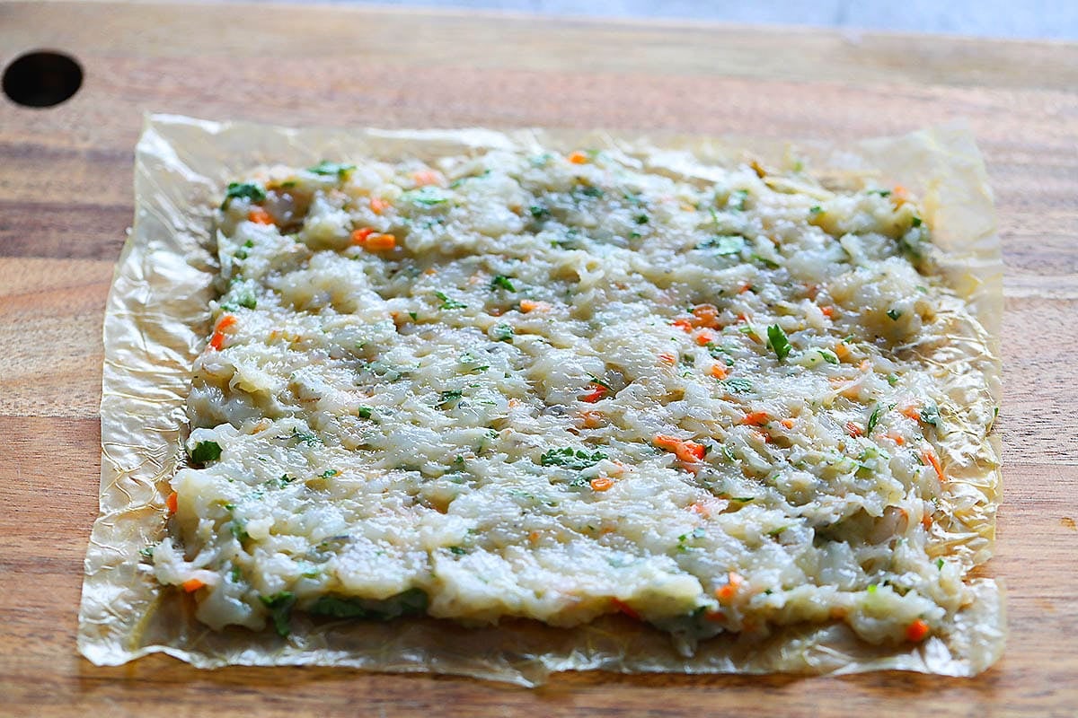 A sheet of bean curd skin topped with a layer of shrimp mixture.