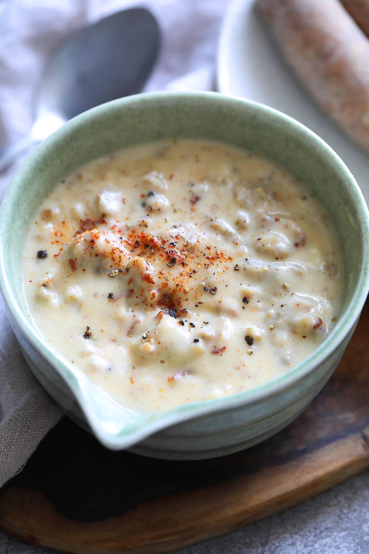Homemade sausage gravy recipe topped with cayenne pepper.