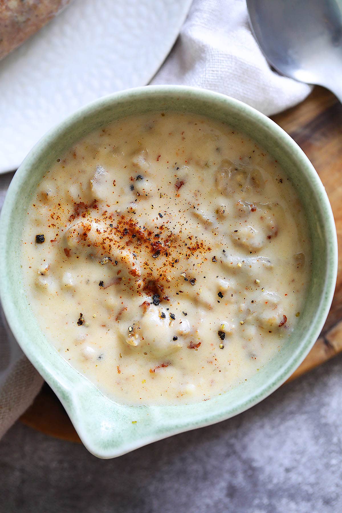 Sausage gravy recipe with pork sausages in a gravy boat.