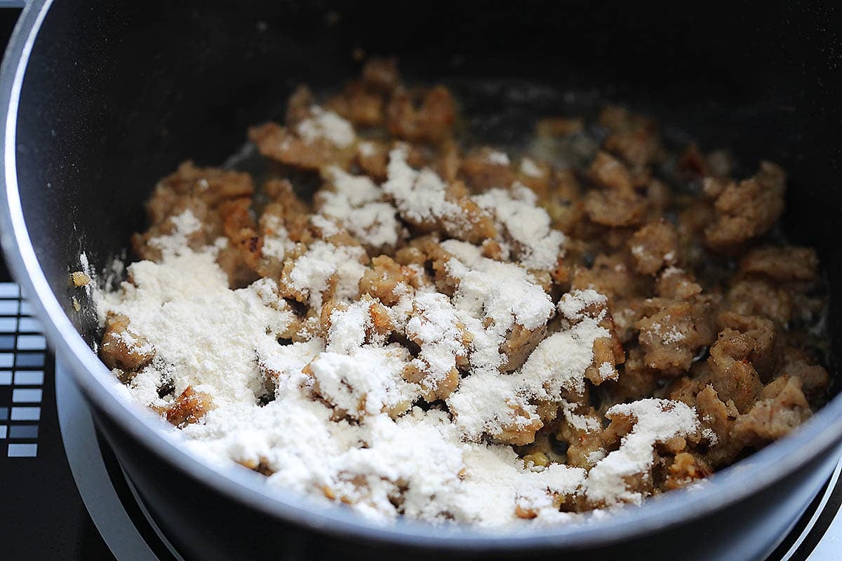 Browned pork sausage and flour in a saucepan.