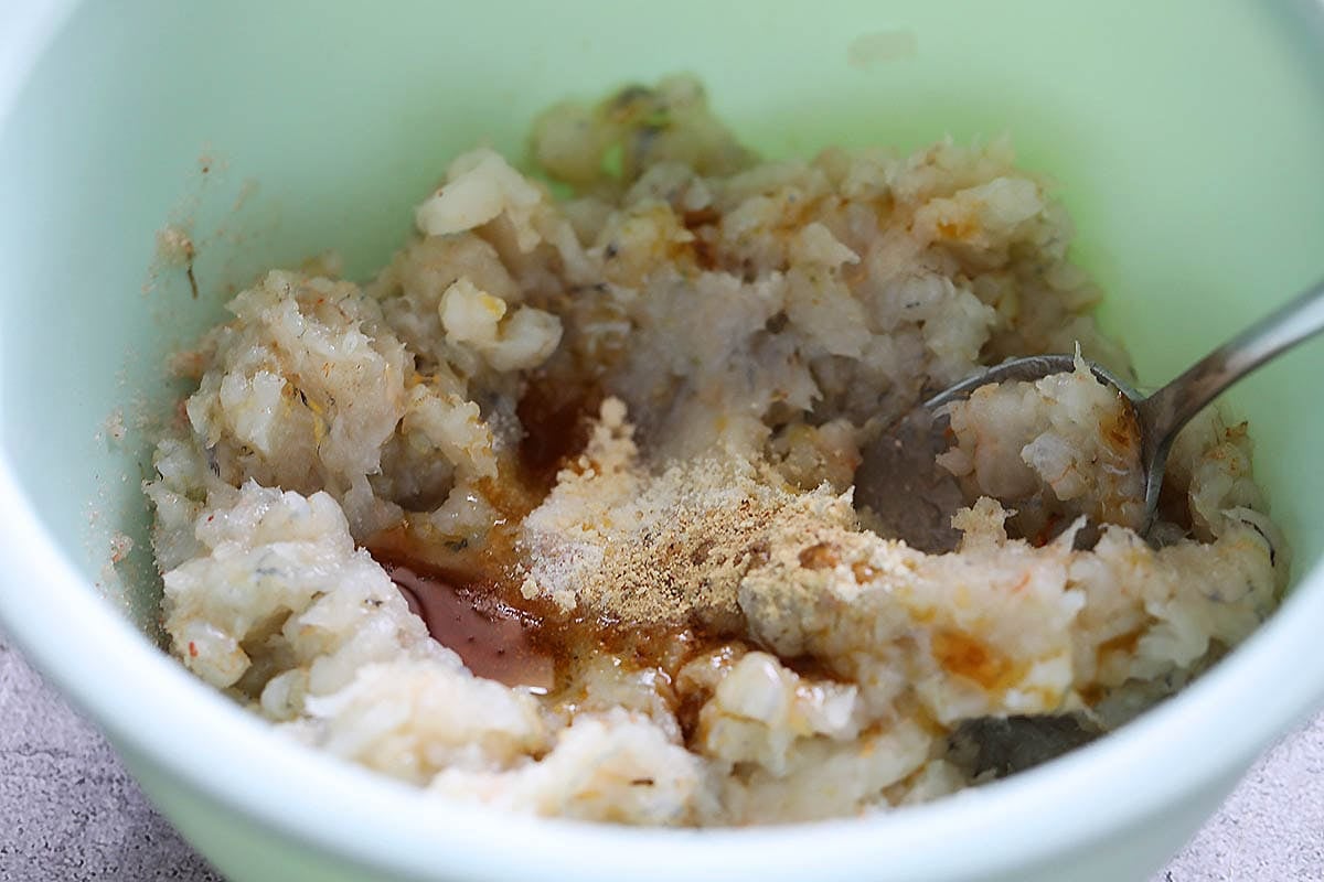 Minced shrimp, shrimp pieces, and seasonings in a bowl.