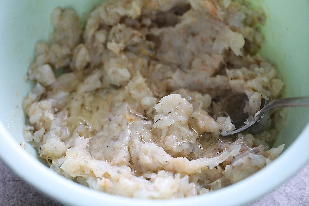 Shrimp mixture and egg white in a bowl.
