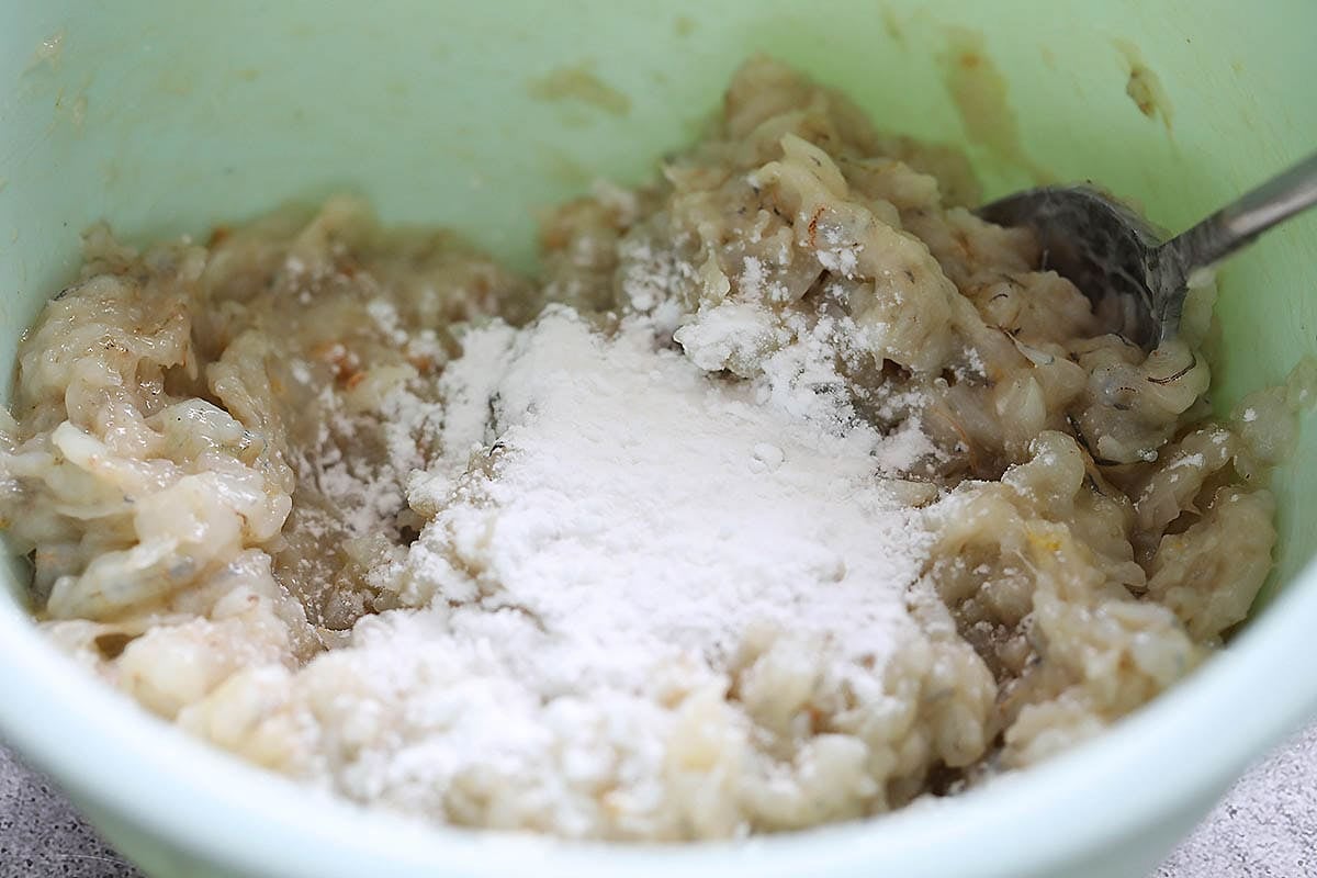 Shrimp mixture and potato starch in a bowl.
