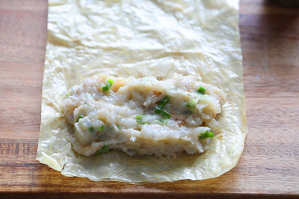 Shrimp filling on a rectangular bean curd skin.