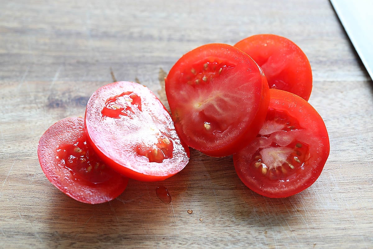 Sliced tomatoes on a chopping board.