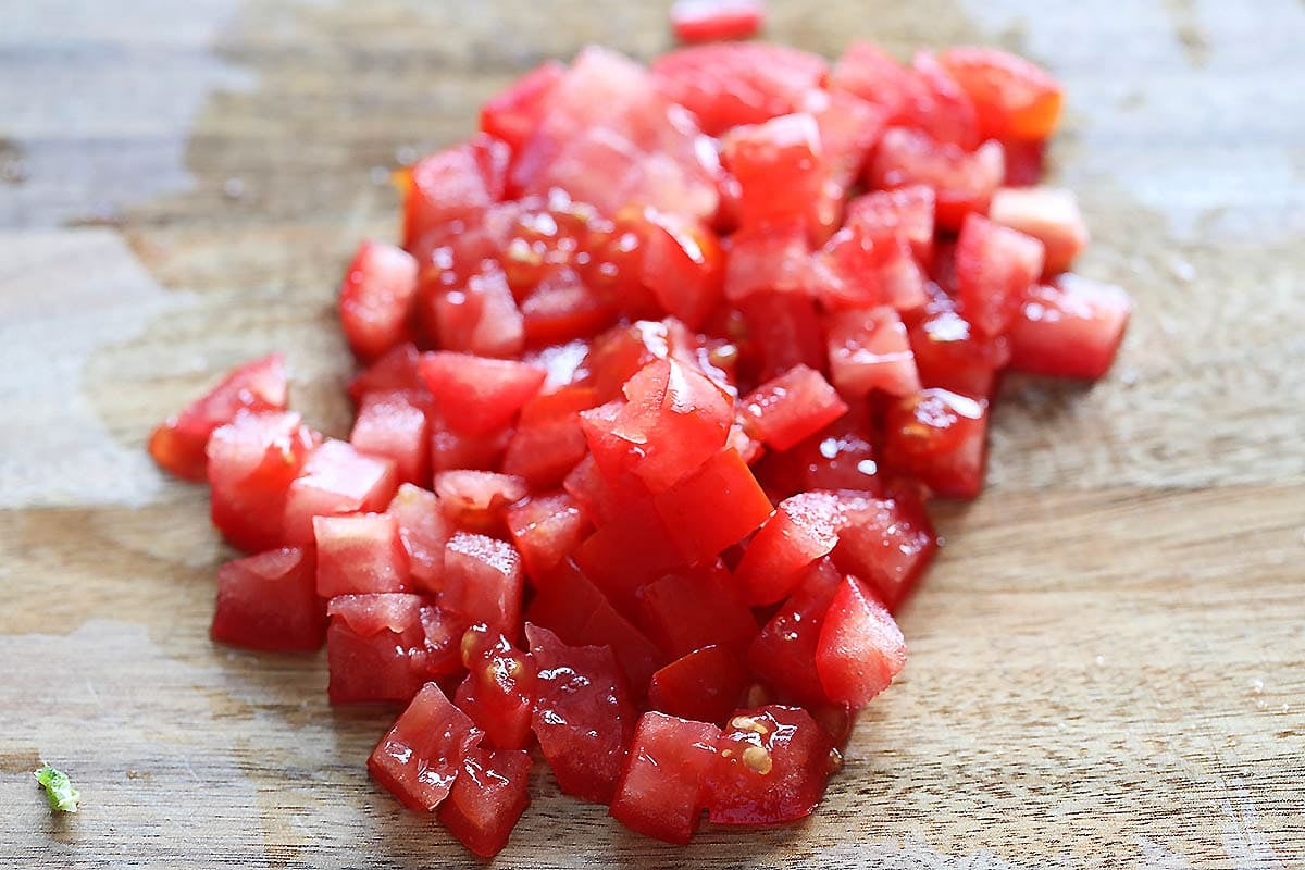 Cubed tomatoes on a chopping board.