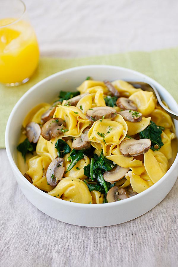 Creamy tortellini recipe with rich buttery mushroom sauce in serving dish ready to serve.