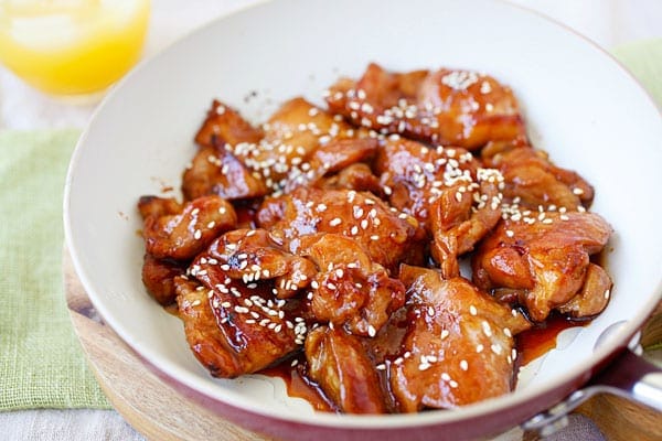 Teriyaki chicken thighs in teriyaki sauce, served on a plate.